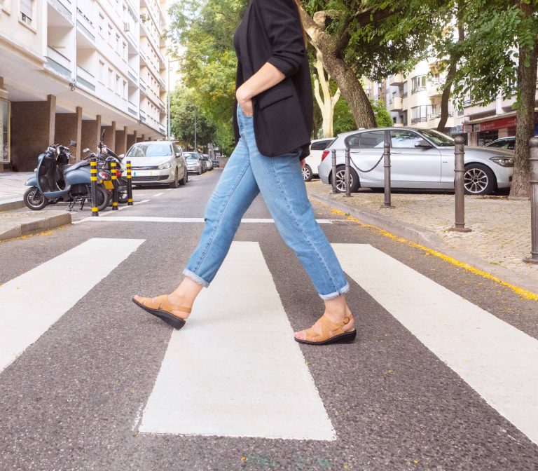 Portina leather sandals worn on a city crosswalk